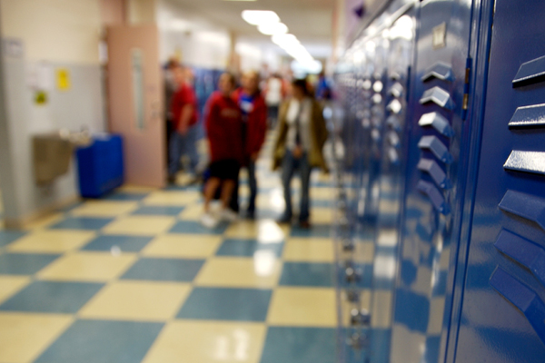 students walking in a hallway with lockers