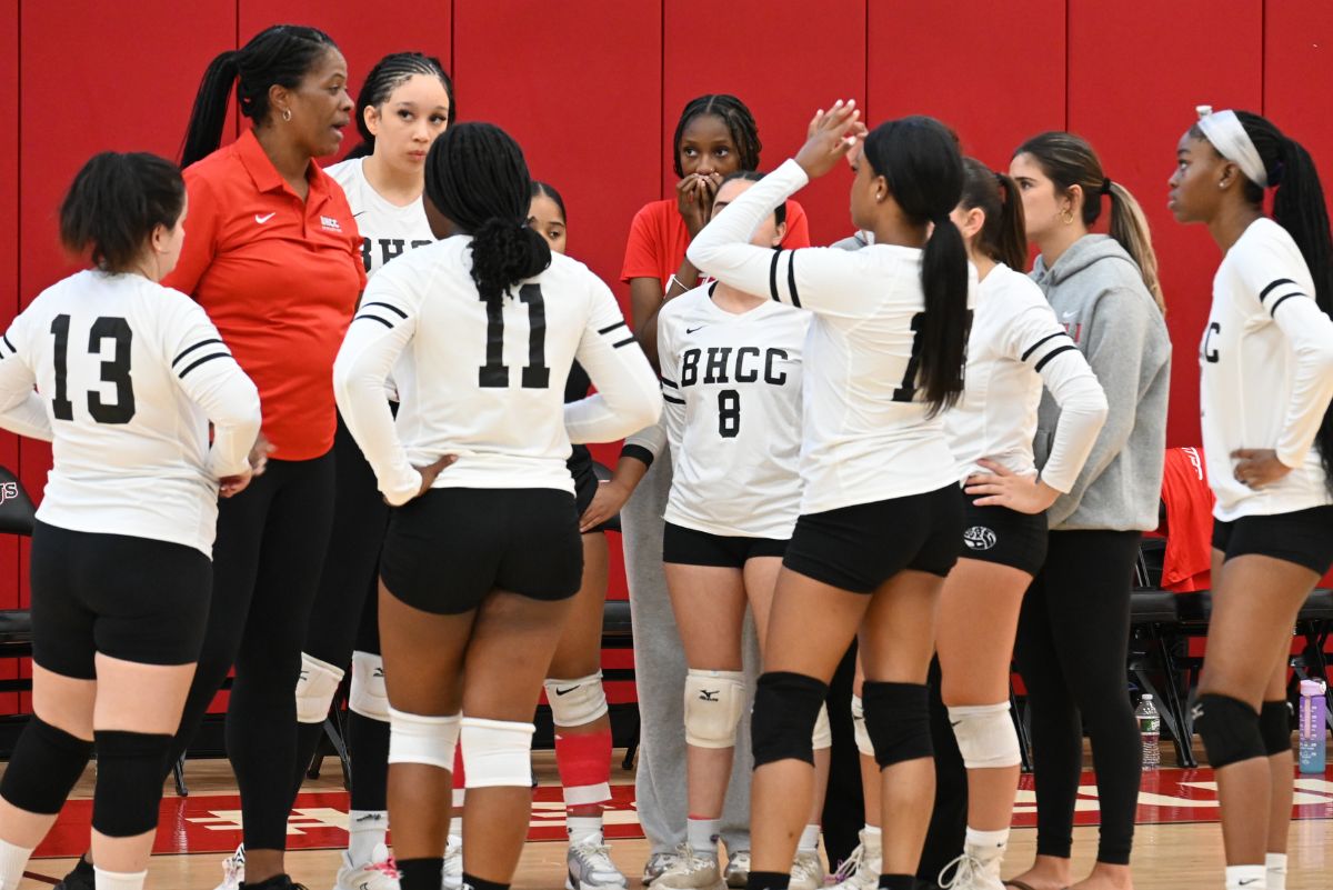 Volleyball player at a bhcc game hovering together