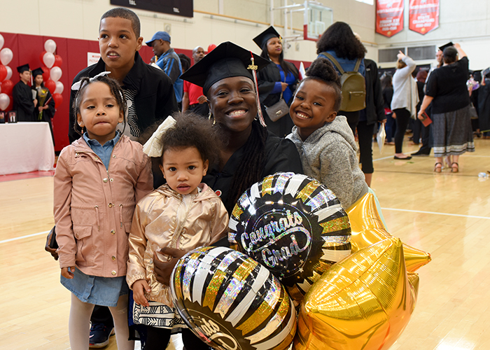student surrounded her family and balloons