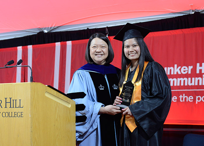 President Eddinger gives female student an award
