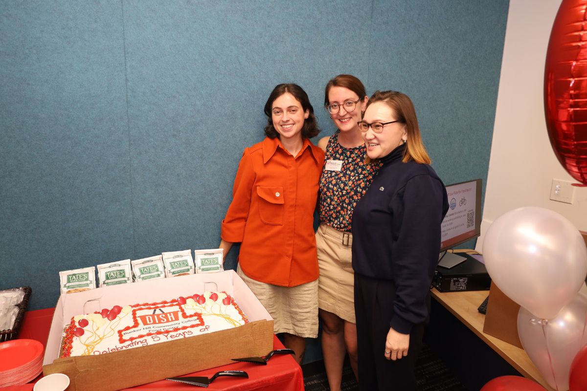 Posing in front of cake