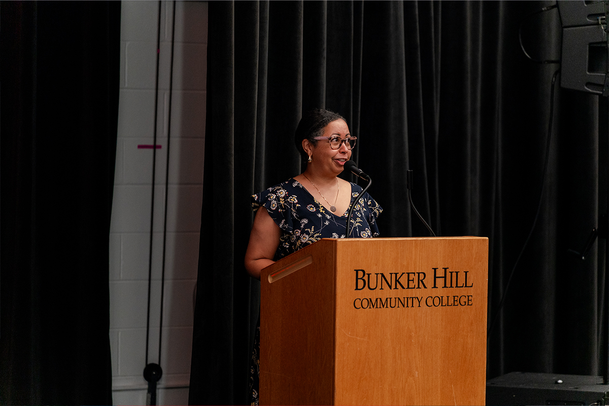 a faculty member giving a speech at a podium