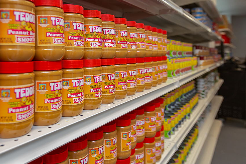 A shelf of peanut butter jars