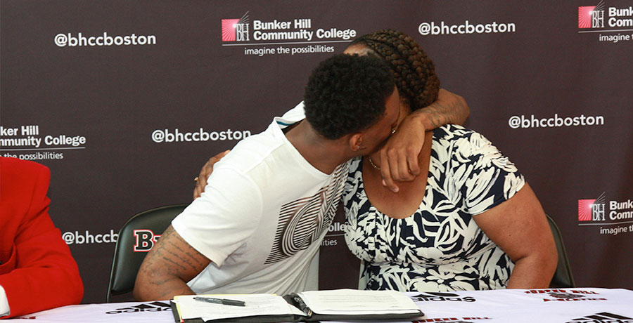 Fredens hugs his mother after signing his letter of intent