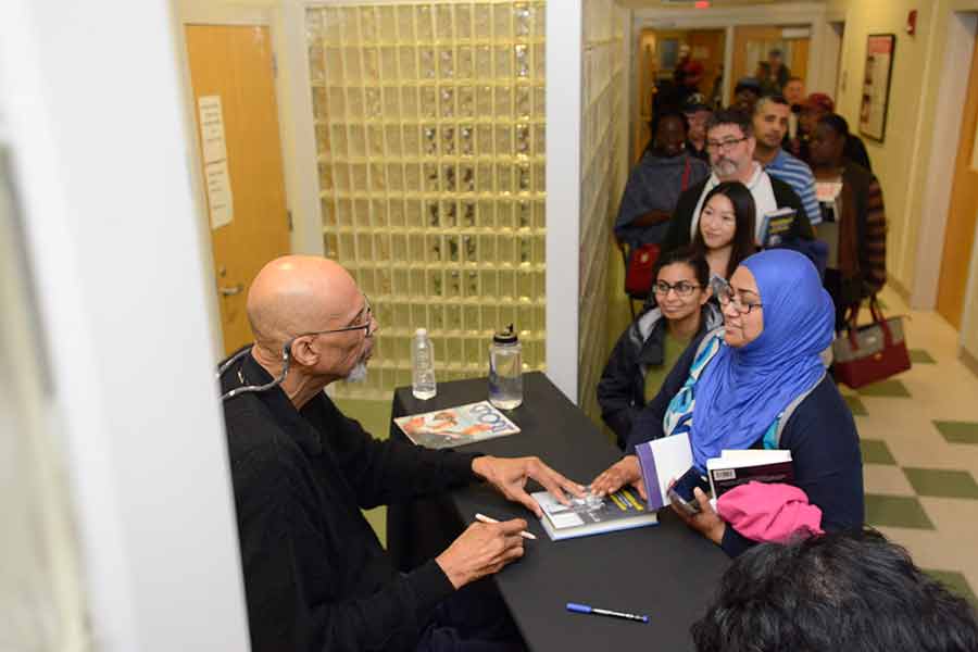 Kareem Abdul-Jabbar signing autographs for BHCC students