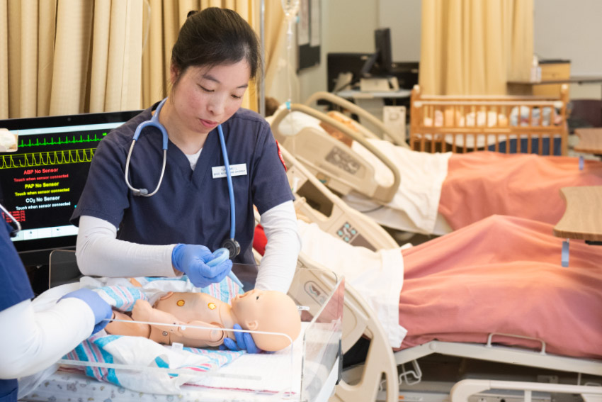 Nurse Performing CPR on an infant Manikin