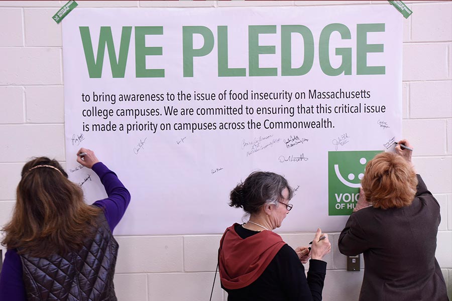 participants signing a pledge poster