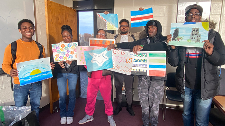 students showing their artwork