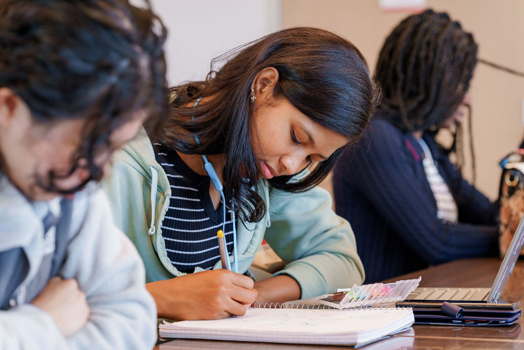 Student writing during class