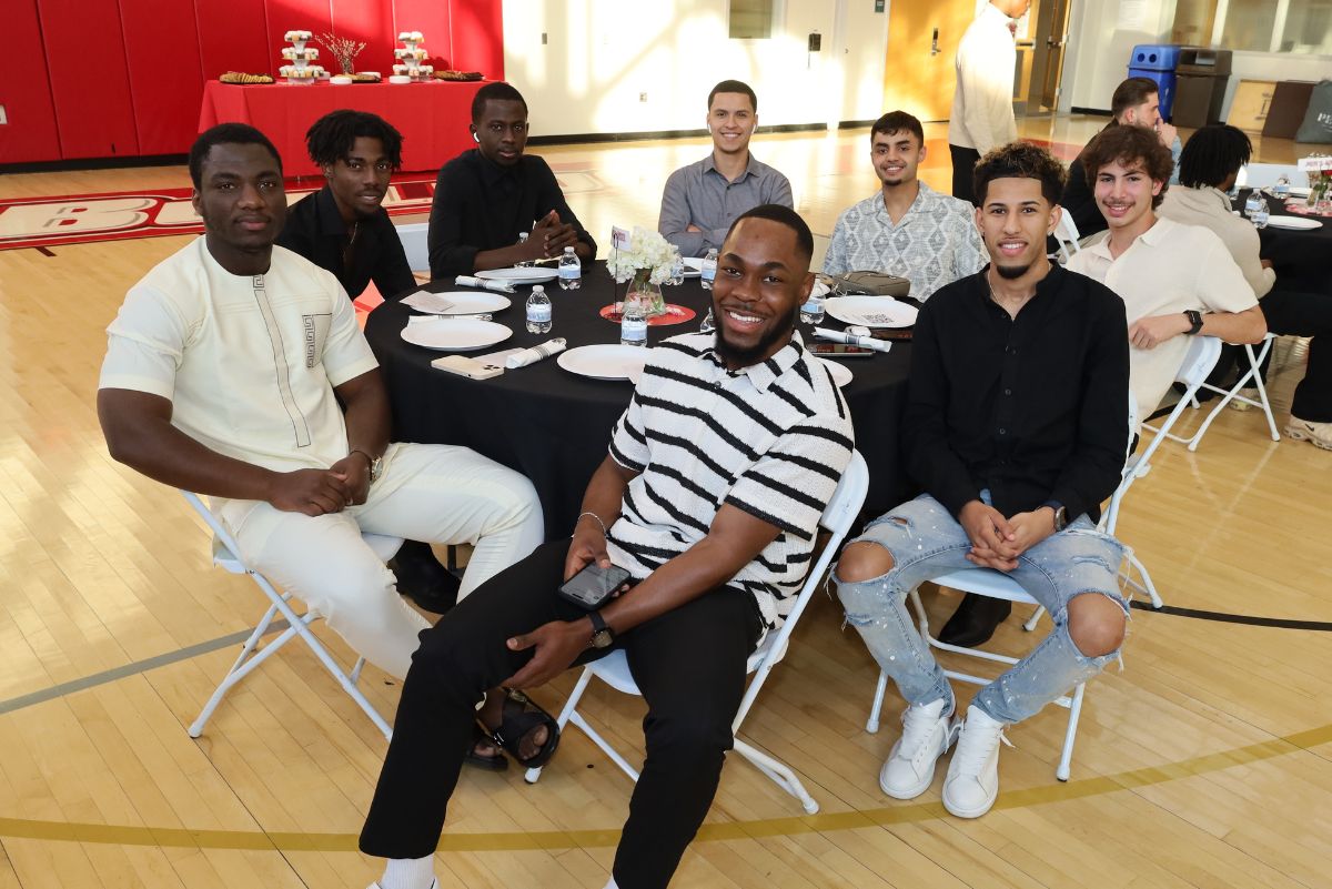 Athletic students at table