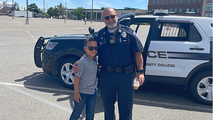 Officer posing with a child for a picture