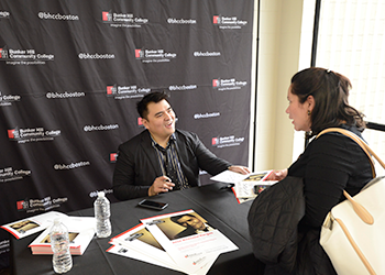Jose Vargas speaking with a student at his book signing